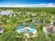 Aerial view of a community pool area featuring blue sunshades and lounge chairs at 15822 Woodland Spring Ct, Orlando, FL 32828