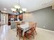 Spacious dining room area with light tile floors and access to a kitchen, offering a relaxed ambiance at 15822 Woodland Spring Ct, Orlando, FL 32828