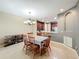 Open dining room with tile floors next to an open kitchen, providing a welcoming space at 15822 Woodland Spring Ct, Orlando, FL 32828