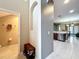 Open concept entryway leads to a half bathroom, open kitchen, dining, and living areas at 15822 Woodland Spring Ct, Orlando, FL 32828