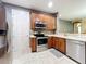 Well-appointed kitchen with stainless steel appliances and wood cabinets, creating a functional space at 15822 Woodland Spring Ct, Orlando, FL 32828
