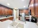 Bright kitchen with stainless steel appliances, tile floors, large sink, and generous counter space at 15822 Woodland Spring Ct, Orlando, FL 32828