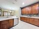 Functional kitchen featuring stainless steel appliances, wood cabinets, and an open view to living space at 15822 Woodland Spring Ct, Orlando, FL 32828
