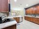 Well-lit kitchen features stainless steel appliances, tile floors, and ample cabinet storage at 15822 Woodland Spring Ct, Orlando, FL 32828
