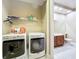 Convenient laundry room equipped with modern washer and dryer, adjacent to a half bathroom for added functionality at 15822 Woodland Spring Ct, Orlando, FL 32828