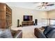 Cozy upstairs living area with TV, shelving, and comfortable seating for leisure time at 15822 Woodland Spring Ct, Orlando, FL 32828