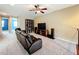 Upstairs sitting area with a dark brown leather sofa and entertainment center for relaxation at 15822 Woodland Spring Ct, Orlando, FL 32828