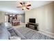 Inviting living room with TV, ceiling fan, and views into the dining and kitchen areas at 15822 Woodland Spring Ct, Orlando, FL 32828