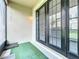 Relaxing patio area featuring stylish double doors and a pleasant green rug at 15822 Woodland Spring Ct, Orlando, FL 32828