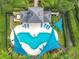 Aerial view of a community pool featuring lounge chairs and sunshades surrounded by lush landscaping at 15822 Woodland Spring Ct, Orlando, FL 32828