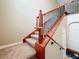 Elegant stairway with carpeted steps and wrought iron railings leading to the upper level at 15822 Woodland Spring Ct, Orlando, FL 32828