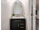 A modern vanity with gold fixtures and a white countertop stands next to an open doorway at 1624 Little Wren Ln, Winter Park, FL 32792