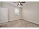 Neutral bedroom features carpet flooring, a ceiling fan, and a window for natural light at 1624 Little Wren Ln, Winter Park, FL 32792