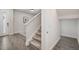 Hallway features a carpeted staircase and wood-look tile flooring that extends to the front door at 1624 Little Wren Ln, Winter Park, FL 32792