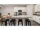 Kitchen featuring white cabinets, gray countertops, a breakfast bar, and stainless steel appliances at 1624 Little Wren Ln, Winter Park, FL 32792