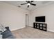 Upstairs living room featuring new carpet, ceiling fan and modern entertainment center at 1624 Little Wren Ln, Winter Park, FL 32792