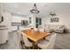 Open layout showcases a dining area, modern light fixture, living room, and an island kitchen at 1624 Little Wren Ln, Winter Park, FL 32792