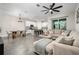 Open-concept featuring a living room with sectional, dining area, and sleek, modern kitchen at 1624 Little Wren Ln, Winter Park, FL 32792