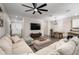 Spacious living room with a large sectional couch, adjacent dining area, and stylish ceiling fan at 1624 Little Wren Ln, Winter Park, FL 32792