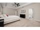 Bright main bedroom featuring a tray ceiling, ceiling fan, and ensuite bathroom access at 1624 Little Wren Ln, Winter Park, FL 32792