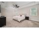 Spacious main bedroom with a tray ceiling, ceiling fan, carpet, and ample natural light at 1624 Little Wren Ln, Winter Park, FL 32792