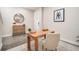 Serene home office boasts stylish decor, a wooden desk, and a round mirror over a cabinet at 1624 Little Wren Ln, Winter Park, FL 32792