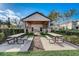 Outdoor picnic area with large wooden tables, and lush landscaping perfect for outdoor dining at 1624 Little Wren Ln, Winter Park, FL 32792