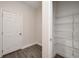 A storage space with wire shelving and wood-look flooring located near a door at 1624 Little Wren Ln, Winter Park, FL 32792