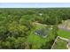 Aerial view of a well-maintained light blue single-Gathering home surrounded by green trees at 17397 Sw 41St Cir, Ocala, FL 34473