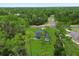 Light blue single-Gathering home with a well-maintained lawn surrounded by tall green trees at 17397 Sw 41St Cir, Ocala, FL 34473