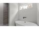 Contemporary bathroom features a soaking tub and a tiled shower at 17397 Sw 41St Cir, Ocala, FL 34473