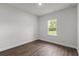 Bedroom with hardwood floors, white walls, natural light, and a large window for an airy feel at 17397 Sw 41St Cir, Ocala, FL 34473