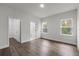 Bright bedroom features hardwood floors, two windows, and doors to the walk-in closet and bathroom at 17397 Sw 41St Cir, Ocala, FL 34473