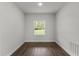 This bedroom has wood-look flooring, a window for natural light, and neutral paint at 17397 Sw 41St Cir, Ocala, FL 34473