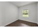 Bedroom with wood-look flooring, and a window overlooking green landscape at 17397 Sw 41St Cir, Ocala, FL 34473