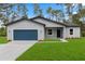 Charming single-story home with a blue garage door, well-manicured lawn, and nicely landscaped front yard at 17397 Sw 41St Cir, Ocala, FL 34473