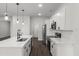 Modern kitchen with quartz countertops, stainless appliances, undermount sink, and white cabinets with matte black pulls at 17397 Sw 41St Cir, Ocala, FL 34473