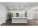 Modern kitchen featuring white cabinetry, stainless steel appliances, a spacious island, and pendant lighting at 17397 Sw 41St Cir, Ocala, FL 34473