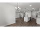 Modern kitchen with quartz counters, white cabinets, stainless appliances connects to the living room and dining area at 17397 Sw 41St Cir, Ocala, FL 34473