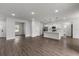 Open-concept living area with laminate flooring, recessed lighting, and a modern kitchen with stainless steel appliances at 17397 Sw 41St Cir, Ocala, FL 34473