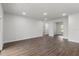 Large open living area with modern wood flooring, bright recessed lighting, and a window offering ample natural light at 17397 Sw 41St Cir, Ocala, FL 34473