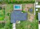 Aerial view of the house with a private screened-in swimming pool at 1778 Woodcrest Ln, Deland, FL 32720