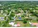 Expansive aerial view showcases the neighborhood homes with lush green landscaping and swimming pools at 1778 Woodcrest Ln, Deland, FL 32720