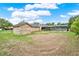 Expansive backyard featuring brick house, brick shed, and screened-in pool at 1778 Woodcrest Ln, Deland, FL 32720