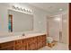 Bathroom featuring a large mirror, vanity with wood cabinets, and a tiled walk-in shower at 1778 Woodcrest Ln, Deland, FL 32720