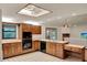 Bright kitchen features wood cabinets, black appliances, and a ceiling fan at 1778 Woodcrest Ln, Deland, FL 32720