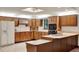 Kitchen featuring lots of wood cabinets, stainless refrigerator, and an island with seating at 1778 Woodcrest Ln, Deland, FL 32720