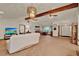 View of living area to front entrance and dining area with neutral colored carpet and white walls at 1778 Woodcrest Ln, Deland, FL 32720