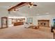 Open floor plan view from living room to kitchen, featuring neutral carpet and brick fireplace at 1778 Woodcrest Ln, Deland, FL 32720