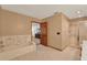 The neutral-toned bathroom features a shower, bathtub, and access to the main bedroom at 1778 Woodcrest Ln, Deland, FL 32720